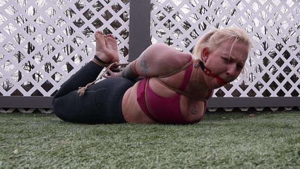 Vivica tightly bound and gagged enduring a painful hogtied on the patio